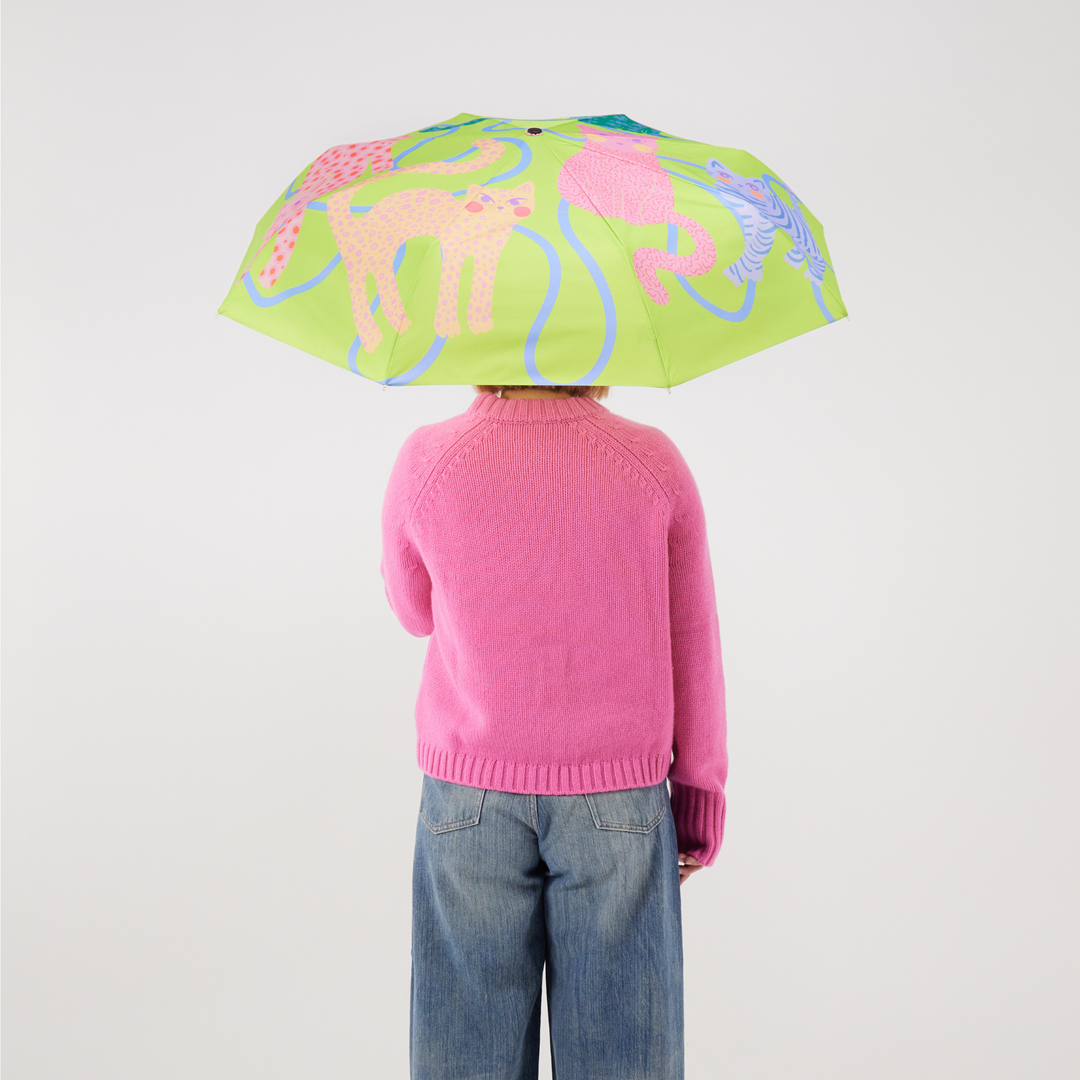 Duck Umbrella - Lime Arty Cats showcased by a person wearing a pink sweater, featuring a vibrant cat-themed canopy.