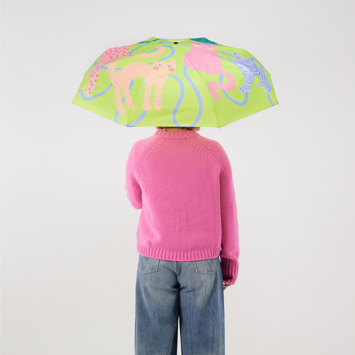 Duck Umbrella - Lime Arty Cats showcased by a person wearing a pink sweater, featuring a vibrant cat-themed canopy.