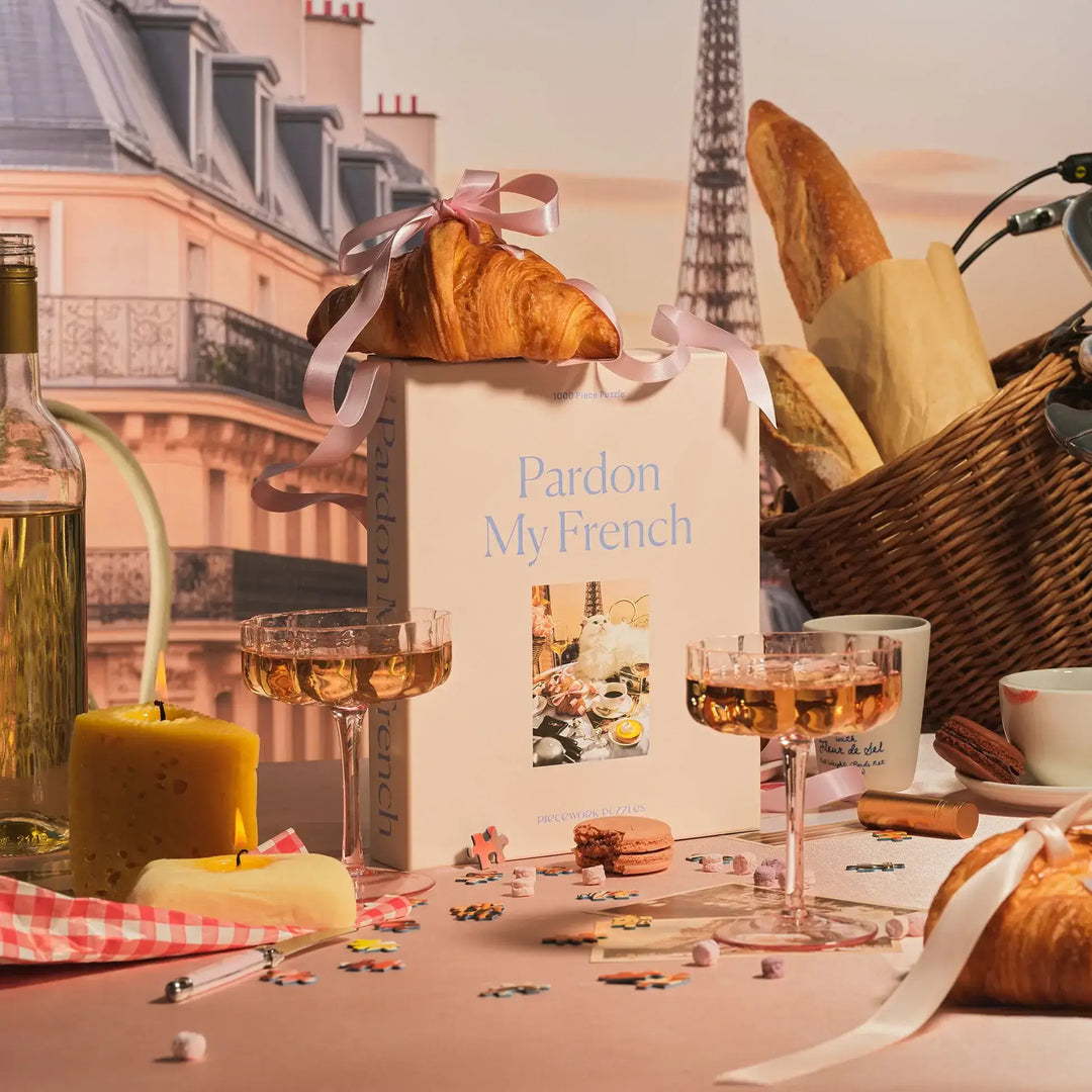 "Pardon My French Puzzle with croissant, wine, and French pastries in Paris-themed setting"