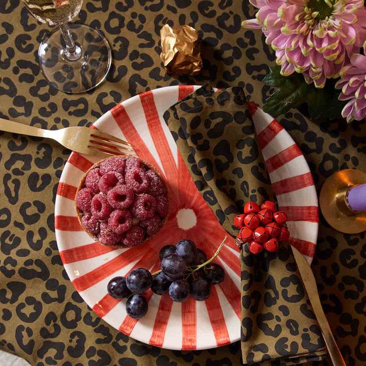 Elegant table setting featuring the Laurene leopard olive napkin, fresh berries, and stylish dishware.