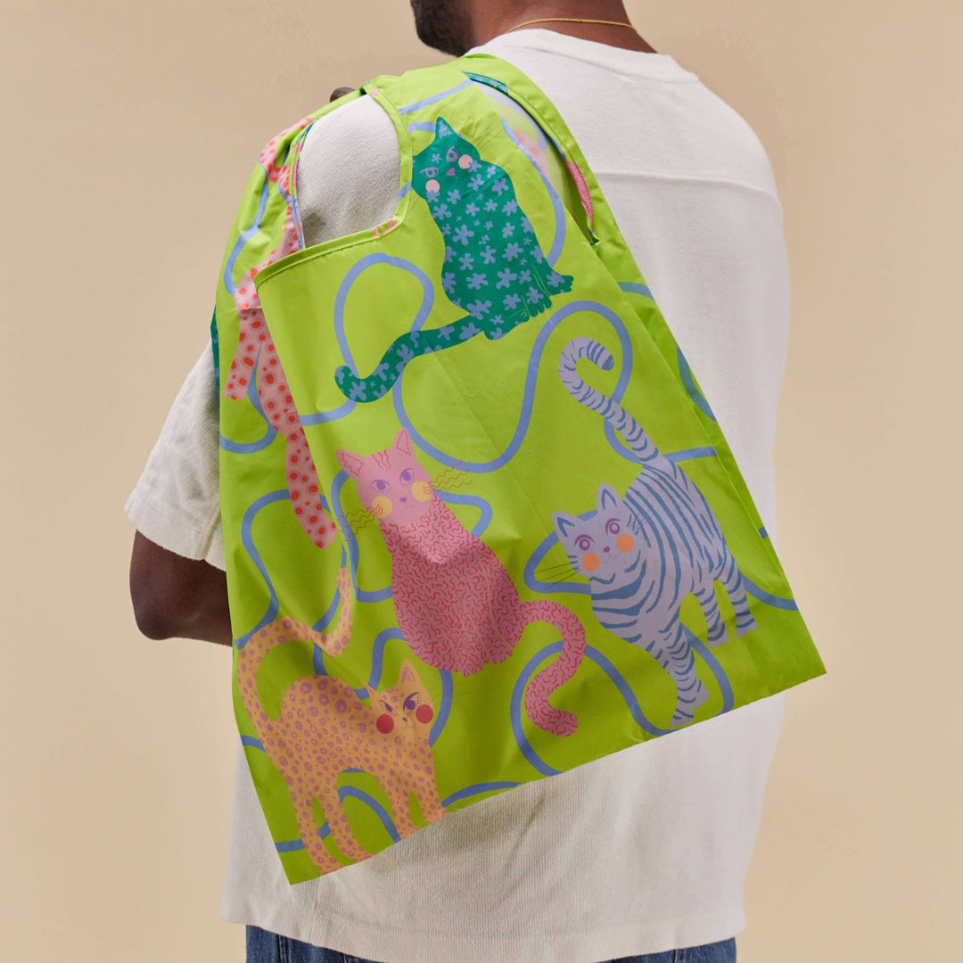 Eco-friendly reusable bag featuring colorful cat designs, showcasing sustainability and style.