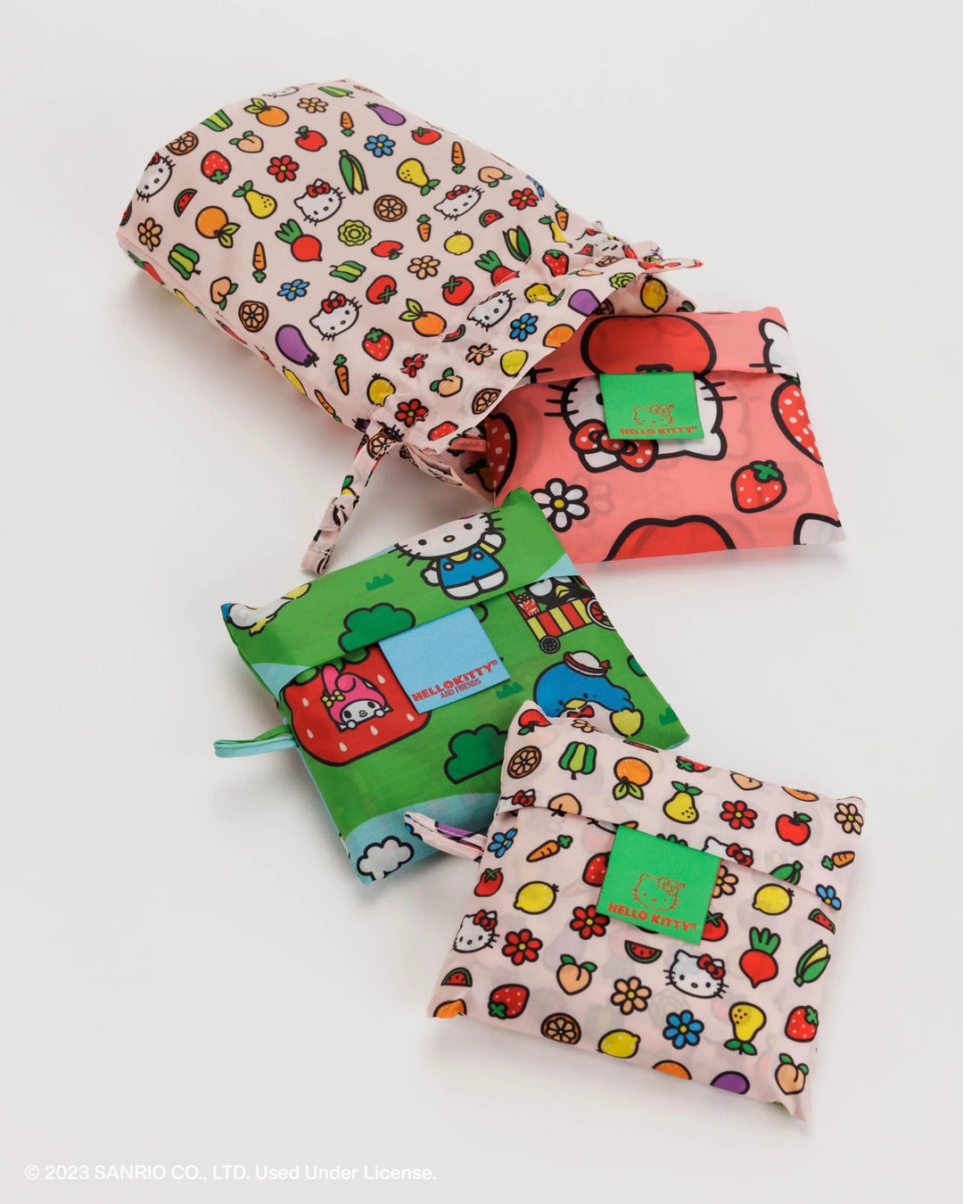 Set of 3 Standard Baggu in Hello Kitty and Friends prints with reusable drawstring pouch, folded and laid out.