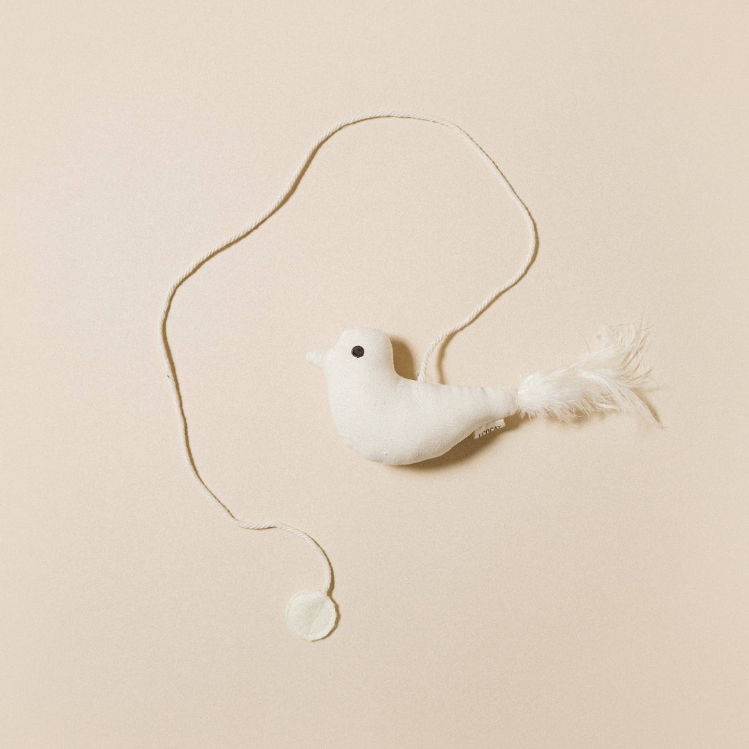 Birdie Cat Toy featuring a soft white bird with feather tail and natural string for playful cat interaction.