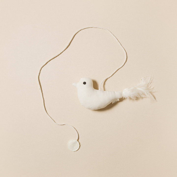 Birdie Cat Toy featuring a soft white bird with feather tail and natural string for playful cat interaction.