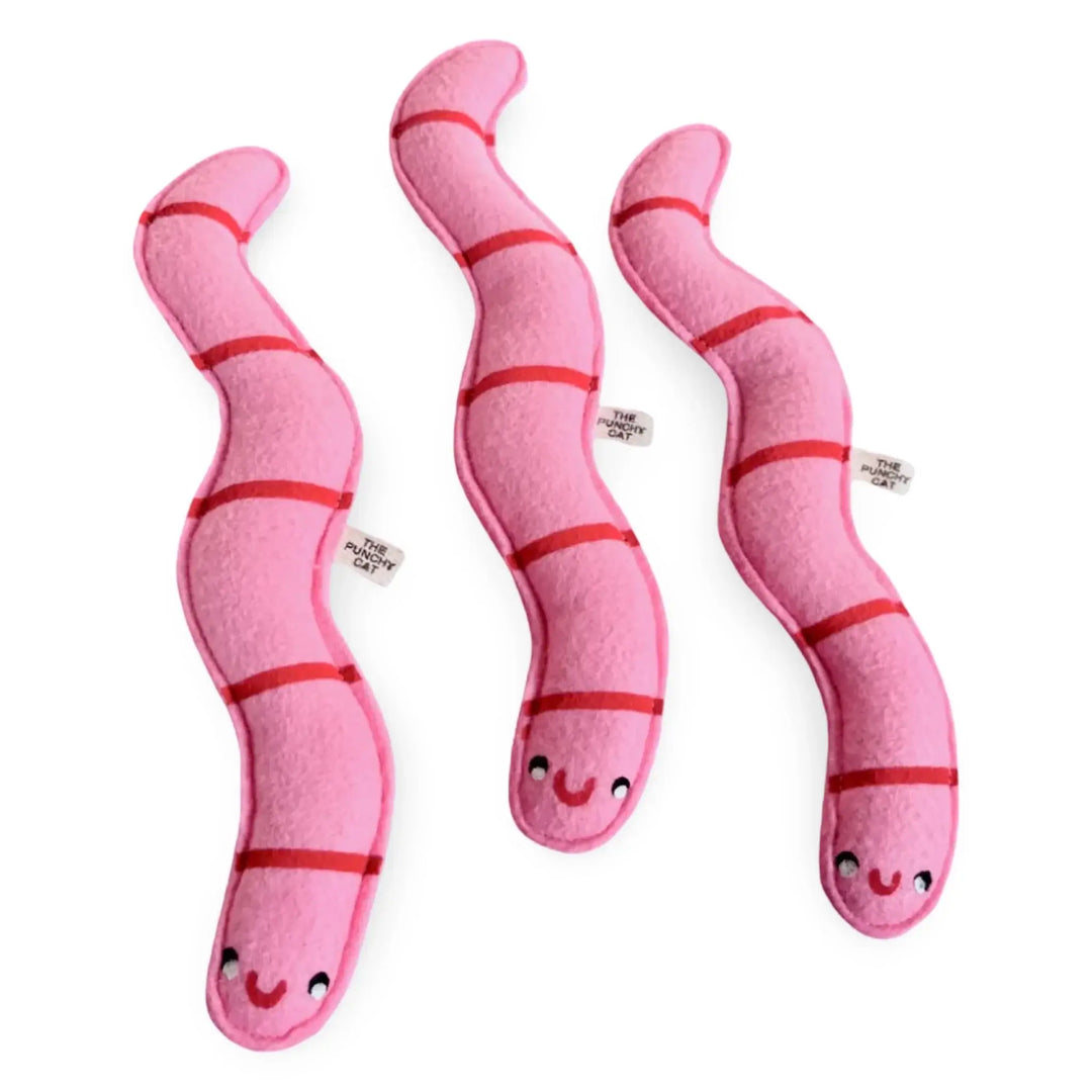 Three pink catnip worms with smiling faces, made of wool felt and filled with organic catnip for playful kitties.