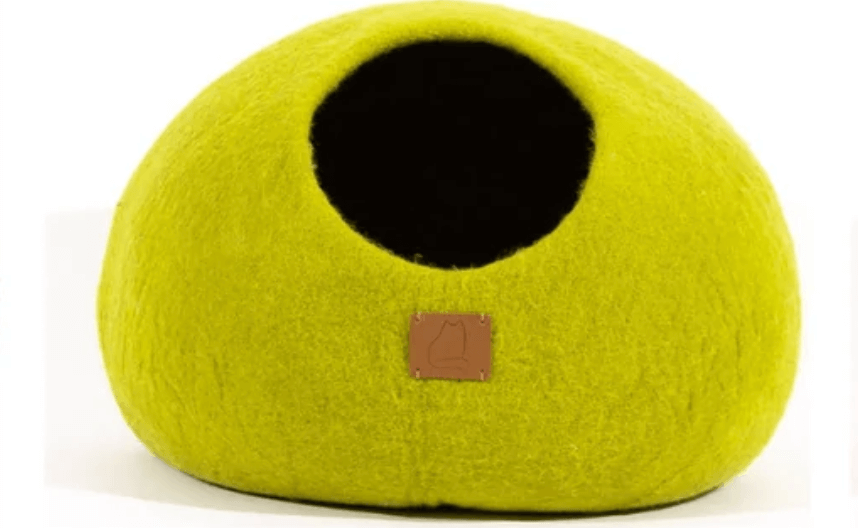 Lime green felted wool cat cave bed providing a cozy haven for cats.