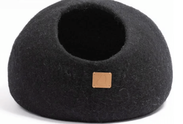 Black felted wool cat cave bed with entrance, offering comfort and style for cats.