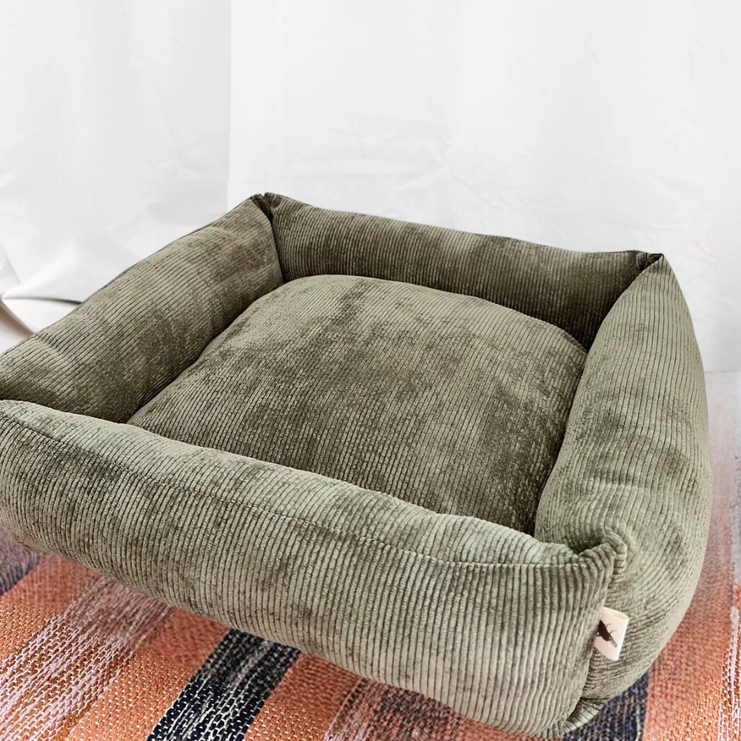 Handmade dark green corduroy pet bed with simple design, perfect for small cats and apartments, adding comfort and coziness to interiors