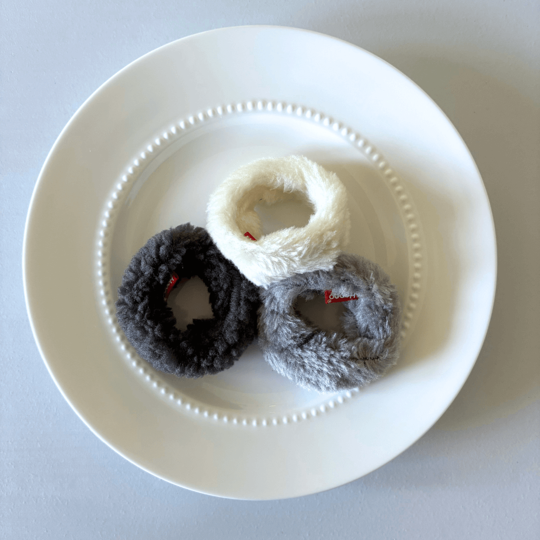 Fluffy mini donut cat toys set of 3 in white, gray, and black colors, displayed on a white plate. Perfect for playful cats.