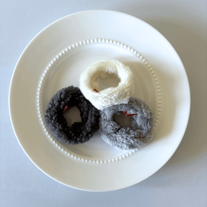 Fluffy mini donut cat toys set of 3 in white, gray, and black colors, displayed on a white plate. Perfect for playful cats.