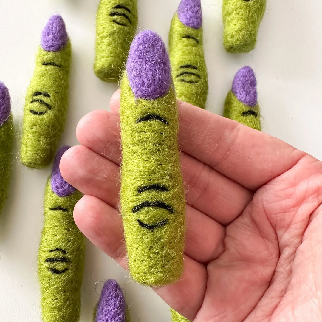 Handmade felted witch finger cat toy from Halloween bundle held in hand