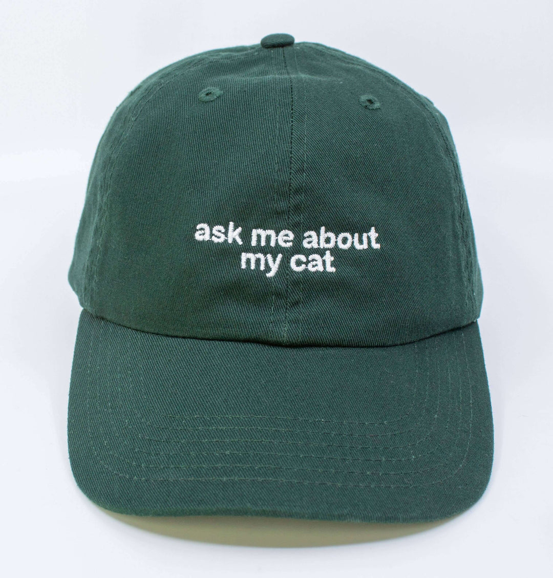 Green embroidered hat with 'ask me about my cat' text, adjustable, 100% cotton, perfect for cat lovers.