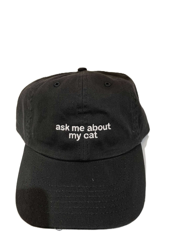 Black embroidered hat with the phrase 'ask me about my cat' in white lettering, adjustable design, perfect for cat lovers.