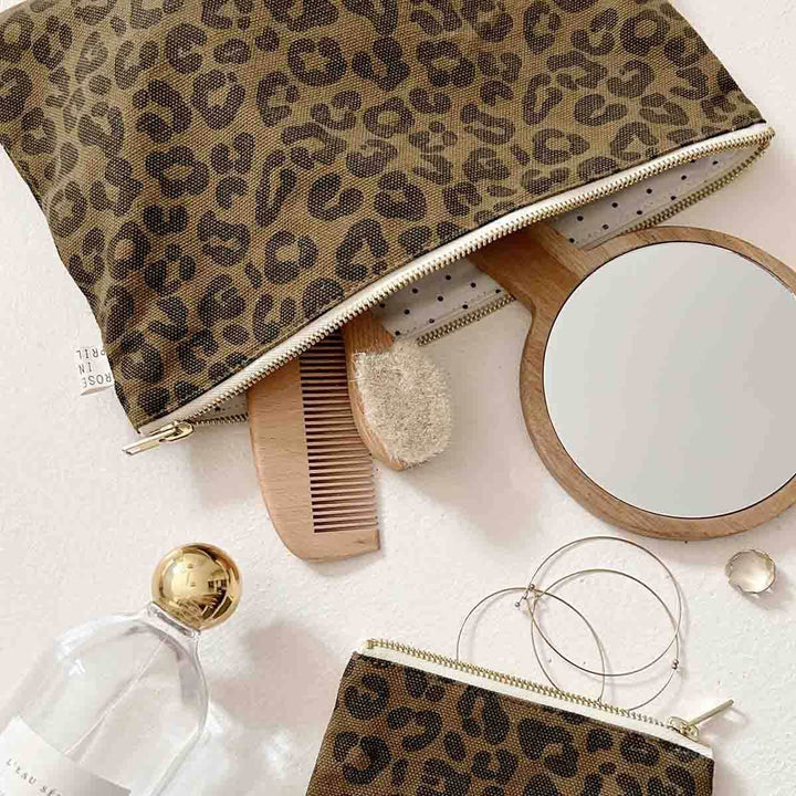 Lili Flat Pouch in olive leopard print with mirror, comb, and accessories on a flat surface.