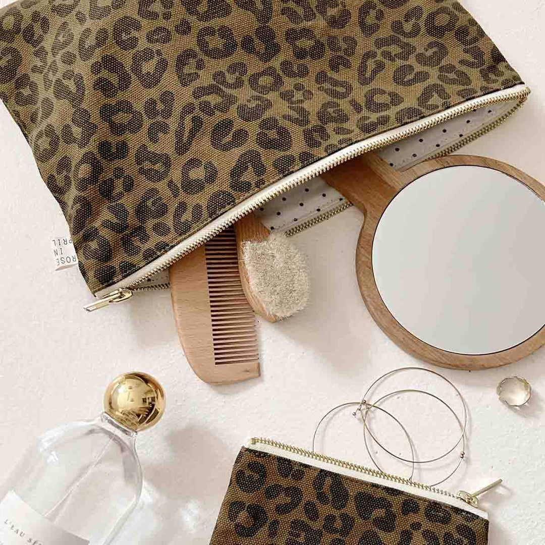 Marie Purse Graou Olive with leopard print, organized with accessories like a mirror and comb.