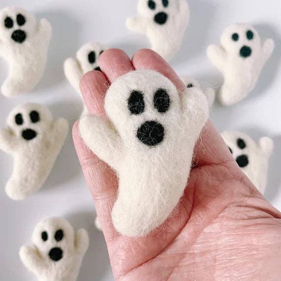 Handmade white ghost cat toy from the Halloween Cat Toy Bundle, held in hand, with multiple similar toys in the background.