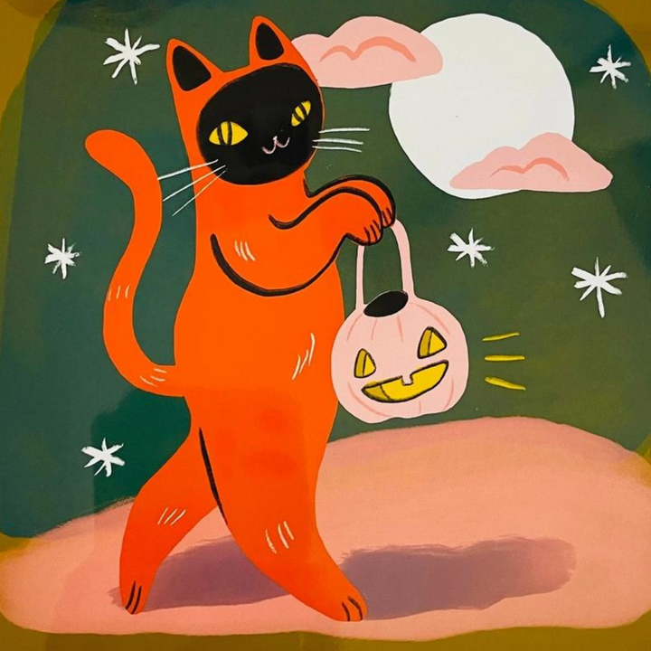 Playful orange cat carrying a jack-o'-lantern bucket under a full moon. Cat prints, cat themed gifts, cat art, gifts for cat lovers.