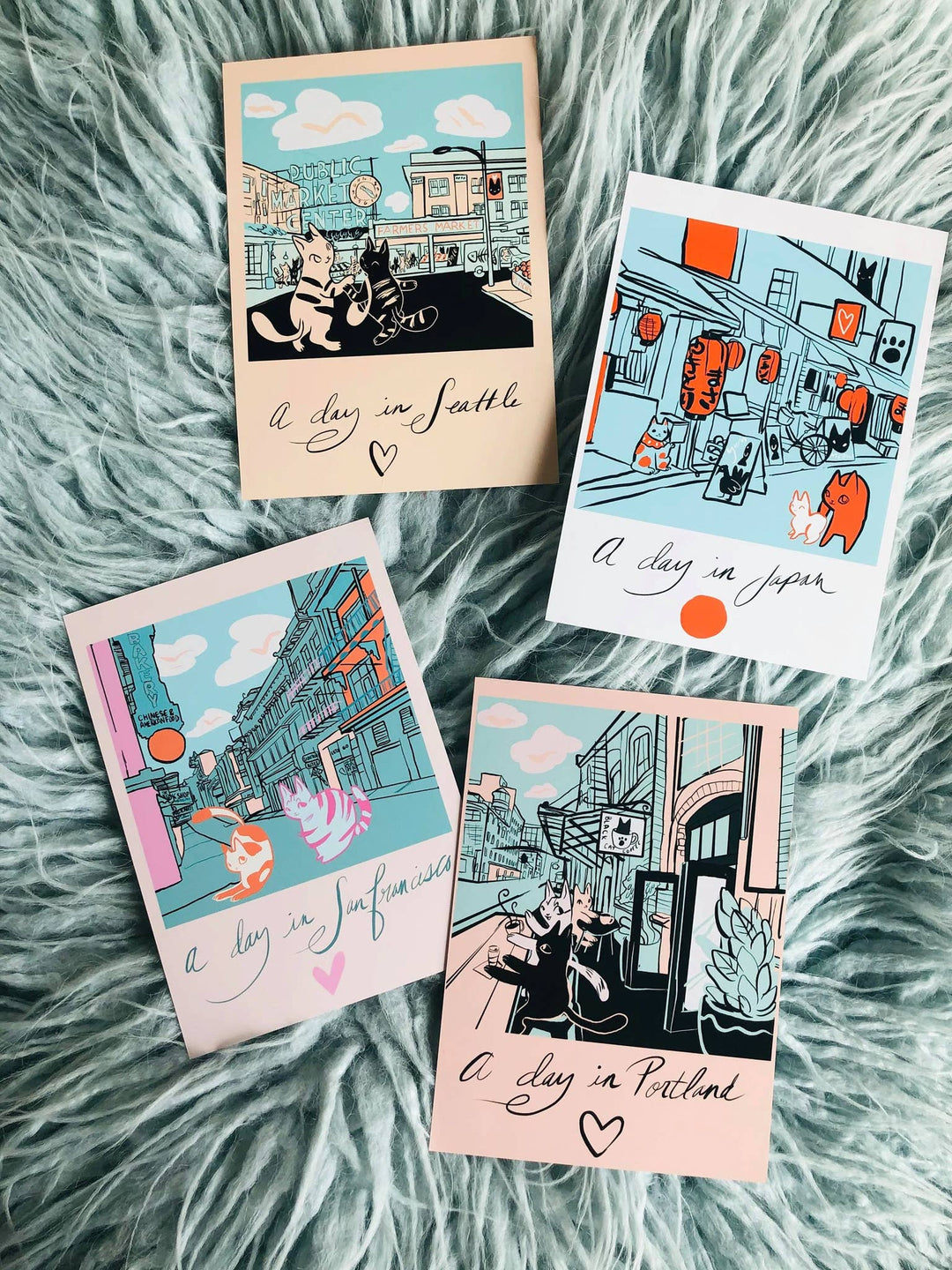 Collection of four cat art prints featuring cities like San Francisco, Seattle, Tokyo, and Portland, perfect cat themed gifts