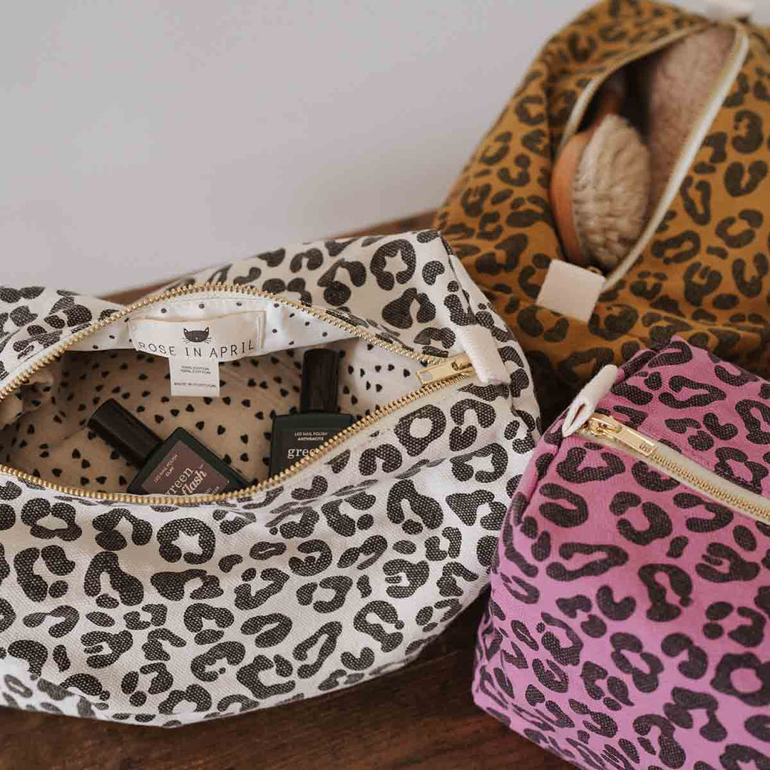 Vic toiletry bags in greige, brown, and pink leopard print, showcasing cotton fabric and stylish organization.