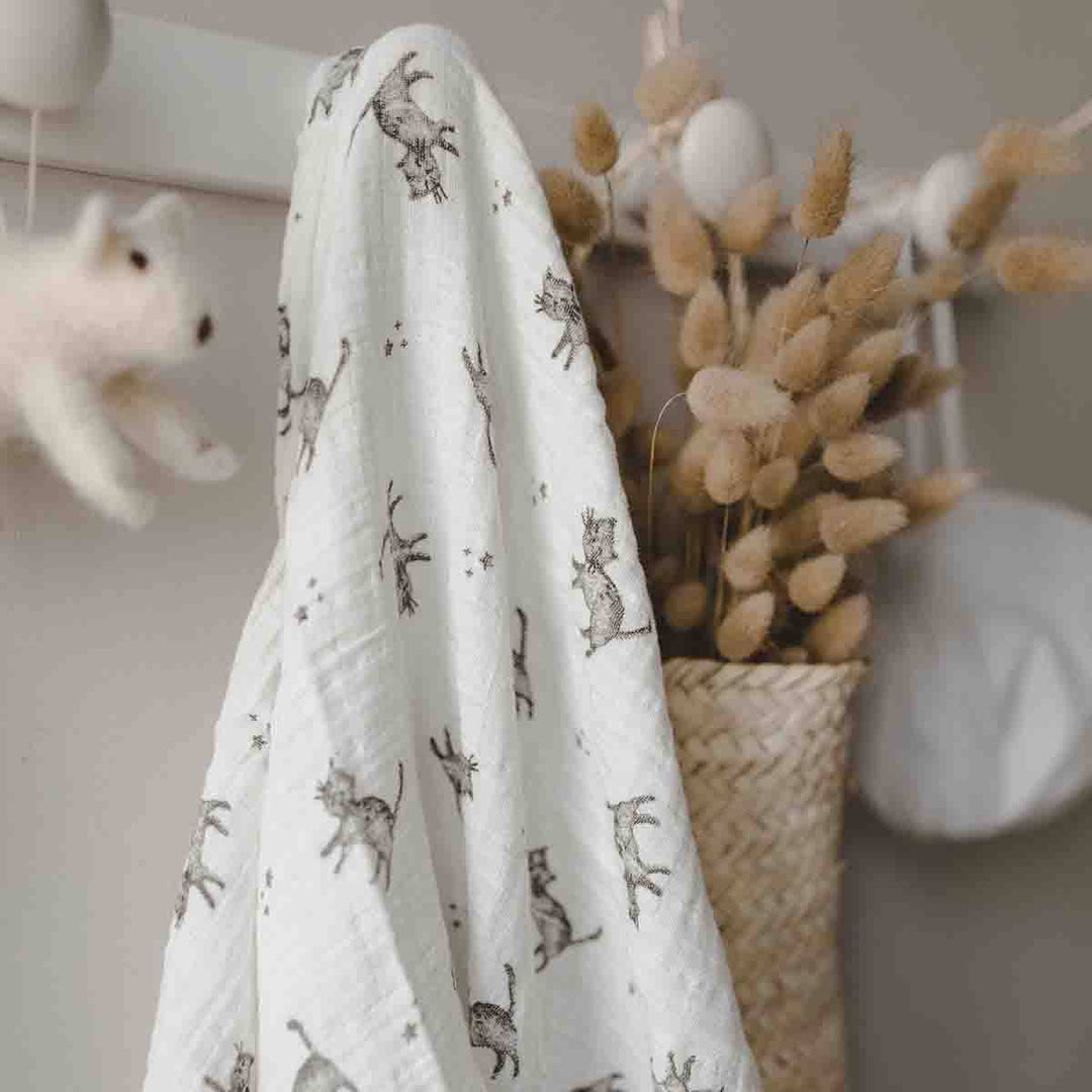 Bianca swaddle in ecru with cat print, stylish baby blanket made from 100% cotton muslin, perfect for gifting.