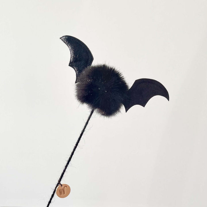 Vampire bat cat toy with soft black furball body and leather wings on a stick, handmade in South Korea, perfect for playful cats.