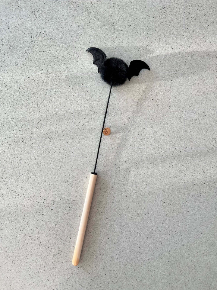 Vampire bat cat toy with furball and wings on a stick, handmade in South Korea, 14x40 cm, perfect for feline play.