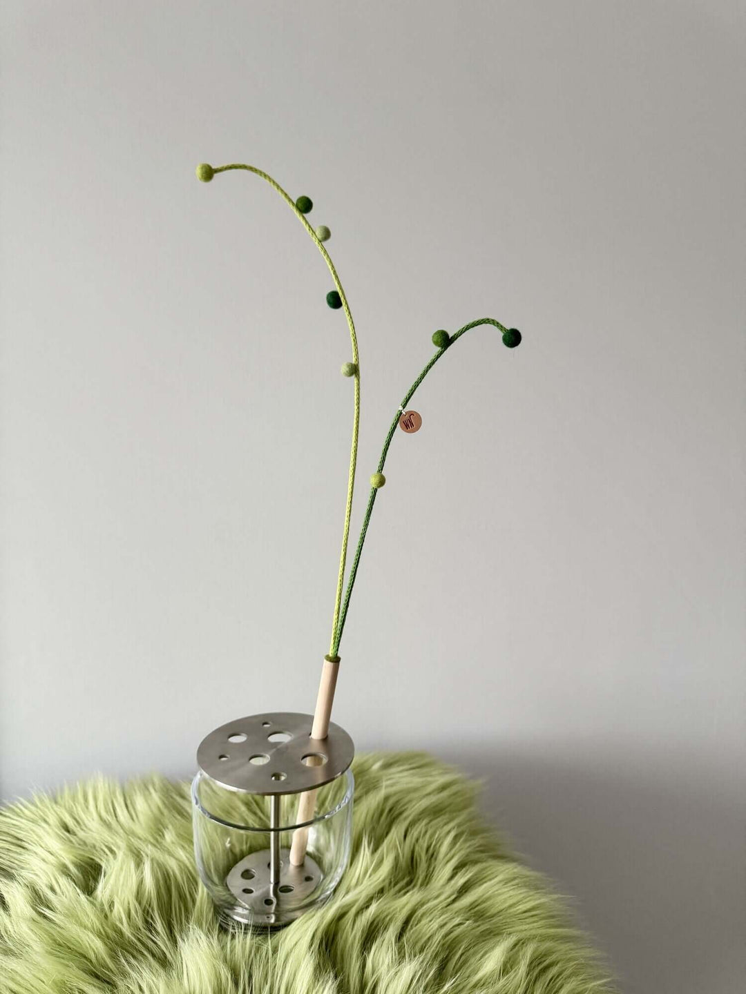 Long String of Pearls wand toy for cats, featuring green yarn branches and a clear base, ideal for indoor play.